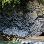 Das querformatige Foto zeigt den Eingang einer Felsenhöhle an der Küste.