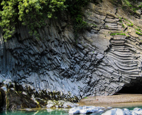 Das querformatige Foto zeigt den Eingang einer Felsenhöhle an der Küste.